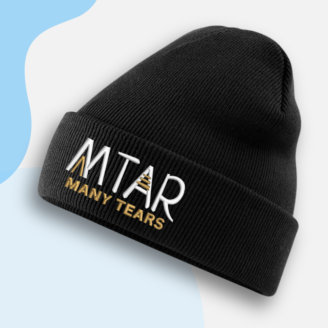 Black beanie with 'MTAR MANY TEARS' text on a light blue background
