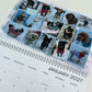 A spiral-bound January 2027 wall calendar page featuring a collage of dog photos in the snow under the words 'SNOWY DAY!'.