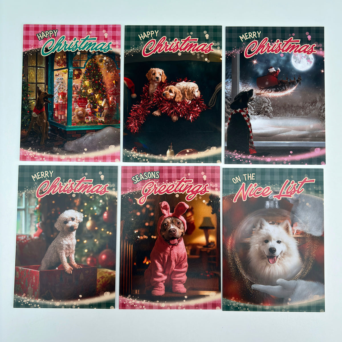 Six Christmas Cards arranged on a white background. The cards feature different dog portraits and holiday scenes, including 'Happy Christmas', 'Merry Christmas', 'Seasons Greetings', 'On the Nice List'.