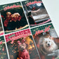 A set of six dog Christmas Cards arranged in a grid, featuring various festive holiday illustrations with text like 'Happy Christmas', 'Merry Christmas', 'Seasons Greetings', and 'On the Nice List'.