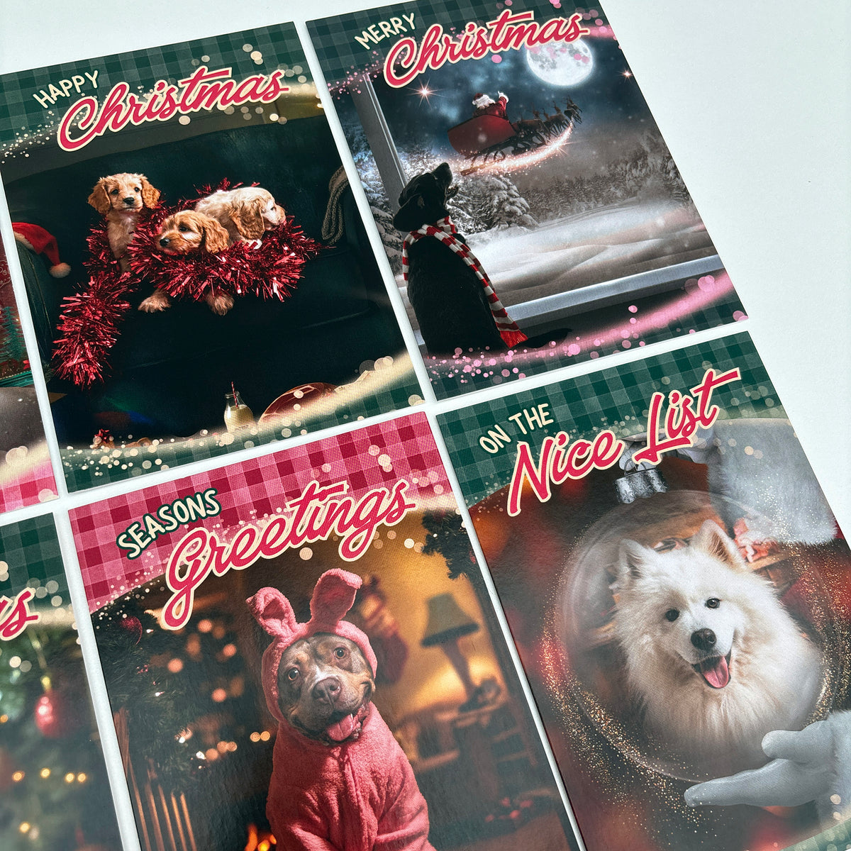 A set of six dog Christmas Cards arranged in a grid, featuring various festive holiday illustrations with text like 'Happy Christmas', 'Merry Christmas', 'Seasons Greetings', and 'On the Nice List'.